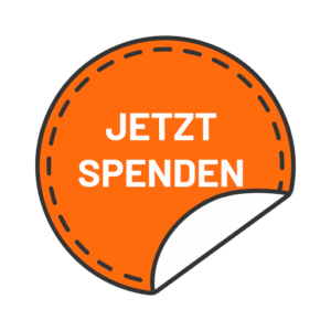 Spendenbutton (Ein orangener Kreis mit schwarzem Rand. Etwas weiter innen folgt ein strichelter, schwarzer Rand. Unten rechts ist der Kreis "umgeklappt" und die weiße Rückseite ist zu sehen. In der Mitte steht in weißer, zweizeiliger Schrift "JETZT SPENDEN":